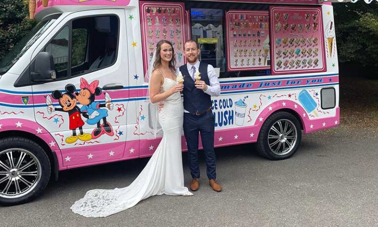 a newly married couple having ice cream near a van